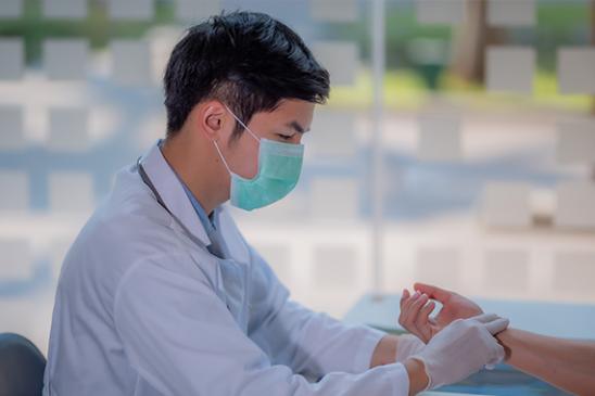 A clinician checking a pulse